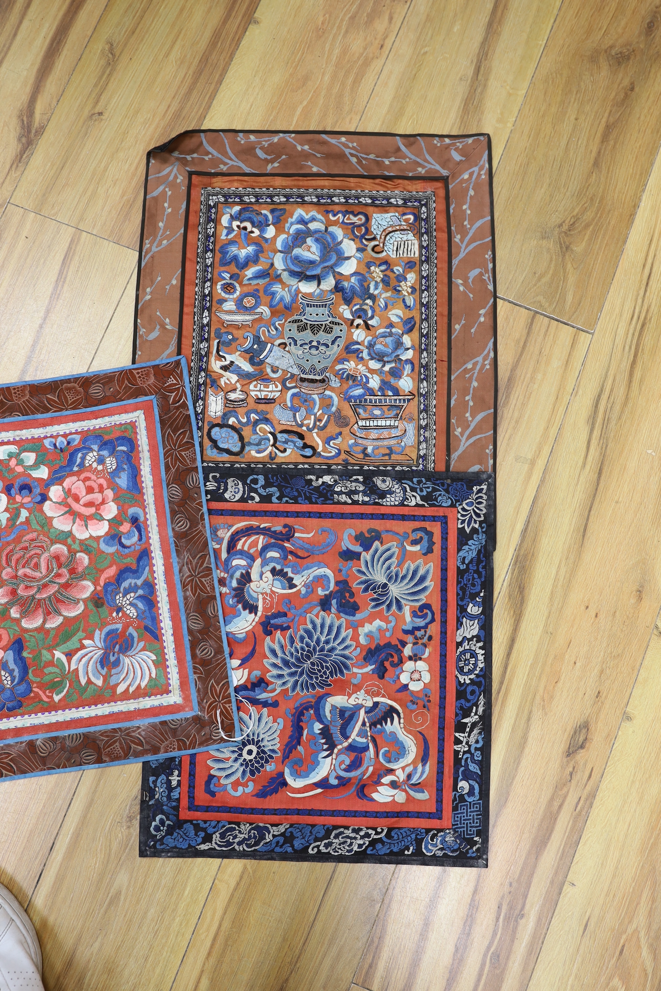 Six panels of Chinese silk embroidered mats, all using mixed stitches including Beijing knot, all bordered with silk brocade